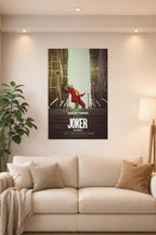 Joker (Joaquin Phoenix) in a bright living room above a beige sofa.