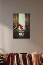 Joker Movie Joaquin Phoenix in a cozy movie room above a brown sofa with popcorn.