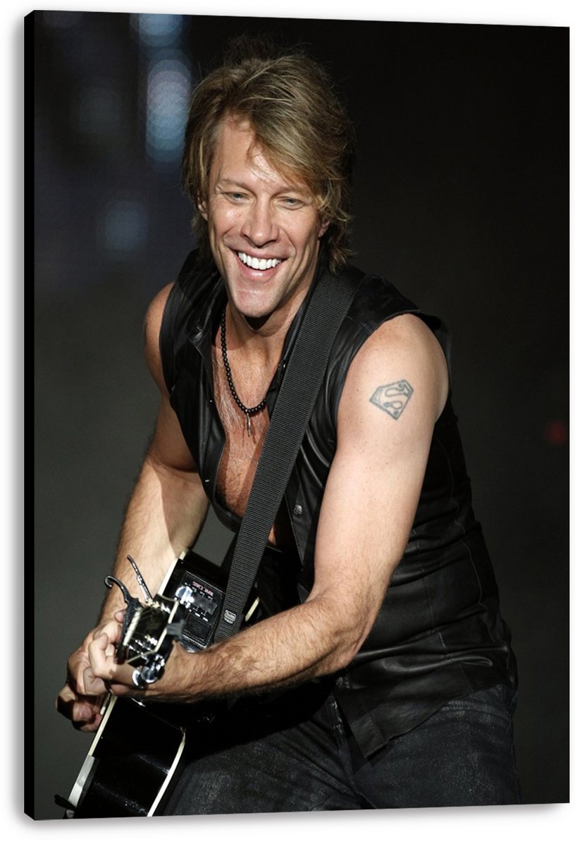 Jon Bon Jovi canvas wall art print features the grinning guitarist in a black leather vest against a dark concert backdrop.