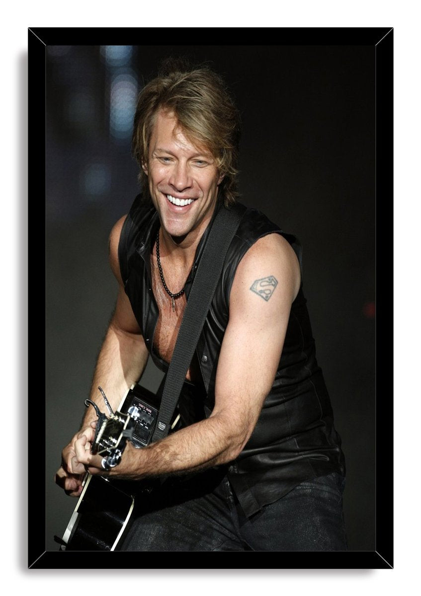 Jon Bon Jovi framed wall art print portrays the musician playing a black guitar, with a Superman emblem tattoo visible on his arm.