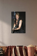 Jon Bon Jovi in a cozy movie room above a brown sofa with popcorn.