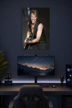 Jon Bon Jovi in a gaming desk setup above a monitor.