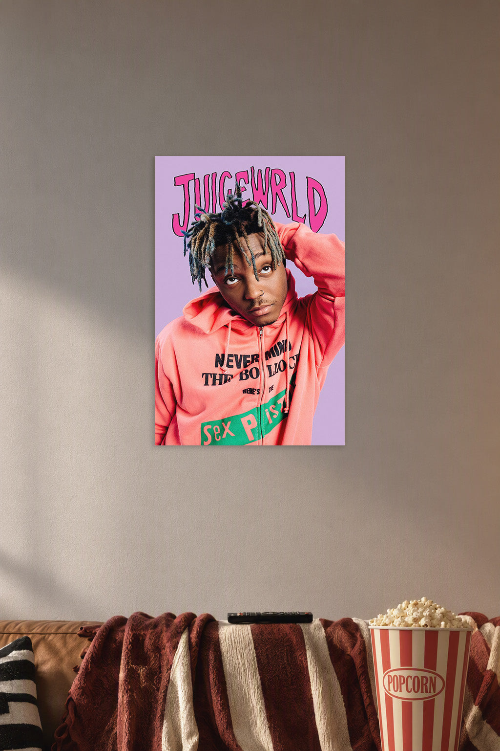 Juice Wrld in a cozy movie room above a brown sofa with popcorn.
