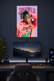 Juice Wrld in a gaming desk setup above a monitor.
