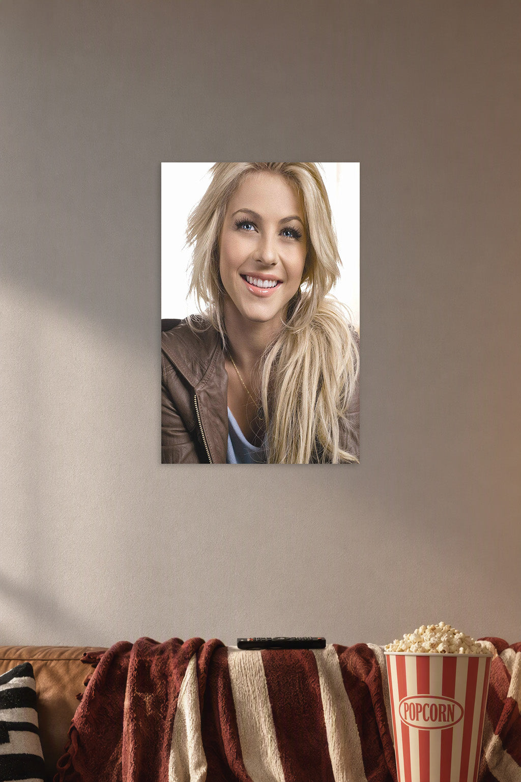 Julianne Hough in a cozy movie room above a brown sofa with popcorn.