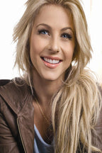 Julianne Hough poster portrait with long blonde hair, blue eyes, and a broad smile in a brown leather jacket.