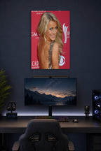 Julianne Hough in a gaming desk setup above a monitor.