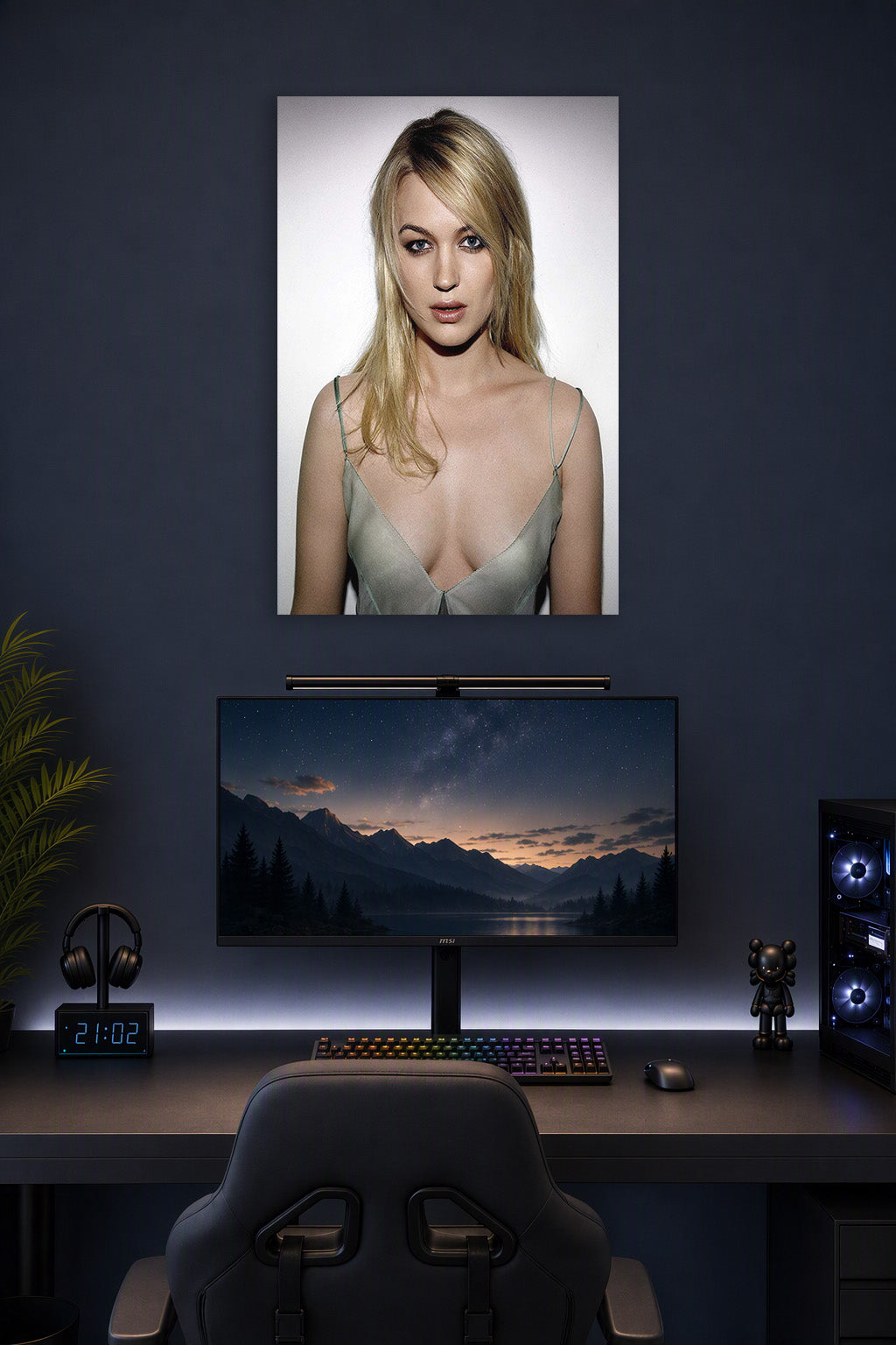 Juno Temple in a gaming desk setup above a monitor.