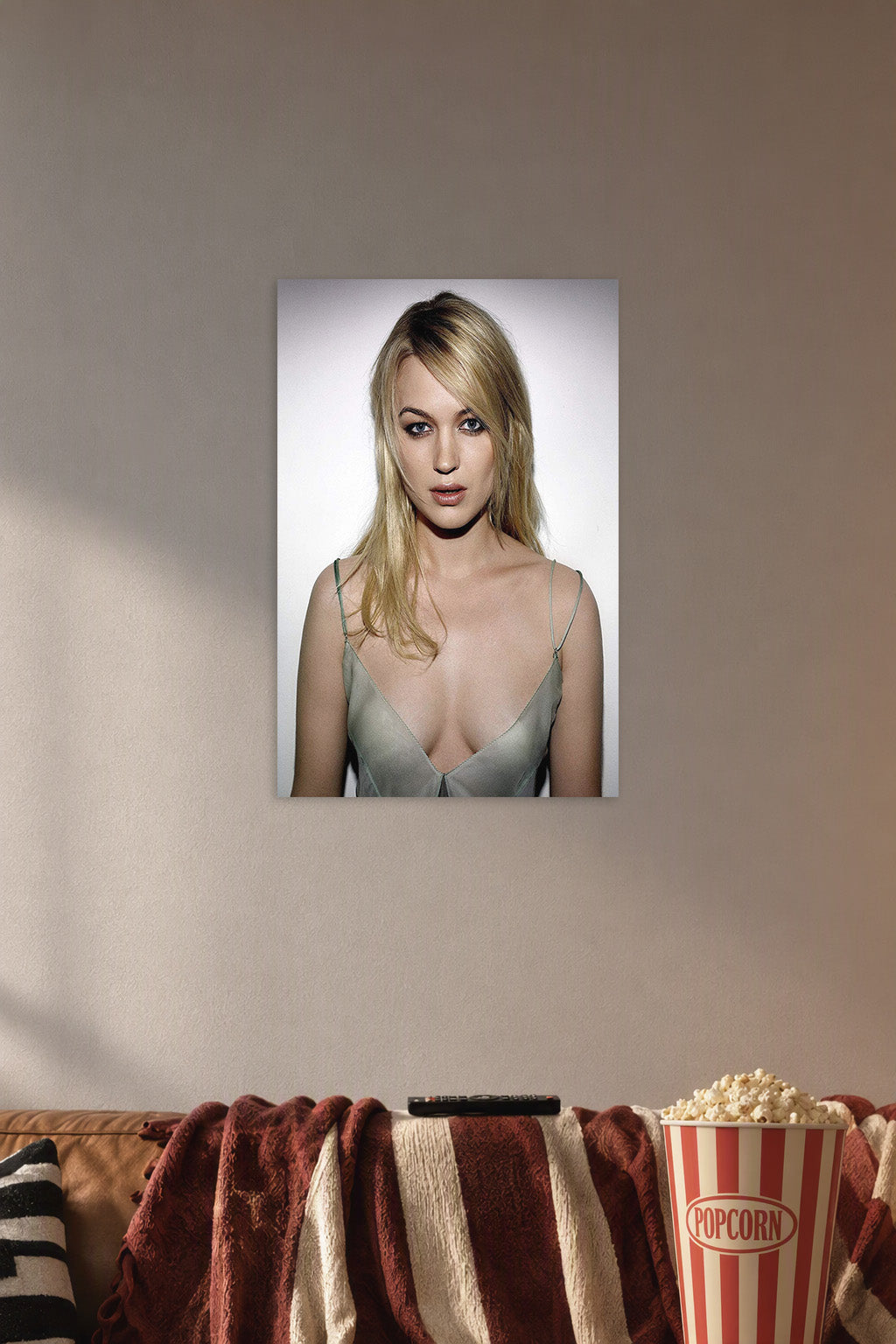 Juno Temple in a cozy movie room above a brown sofa with popcorn.