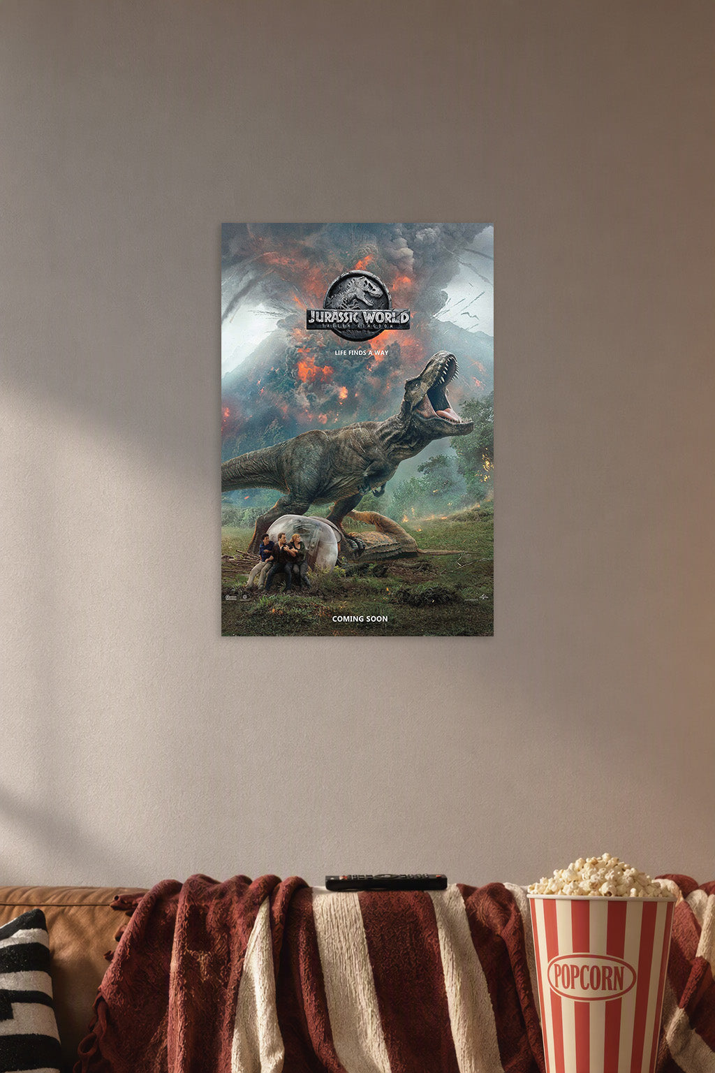 Jurassic World Fallen Kingdom T-Rex in a cozy movie room above a brown sofa with popcorn.