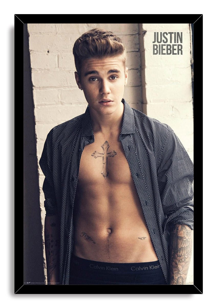 Justin Bieber framed wall art print features a portrait of the singer with chest and arm tattoos in a black frame.