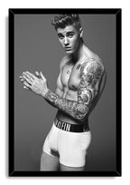 Justin Bieber framed wall art print presents a black-and-white tattooed portrait in white boxer briefs within a black frame.