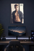 Justin Bieber in a gaming desk setup above a monitor.