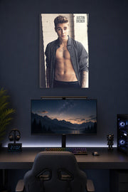 Justin Bieber in a gaming desk setup above a monitor.