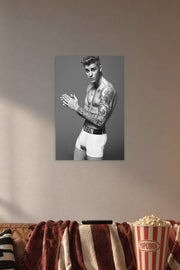 Justin Bieber in a cozy movie room above a brown sofa with popcorn.