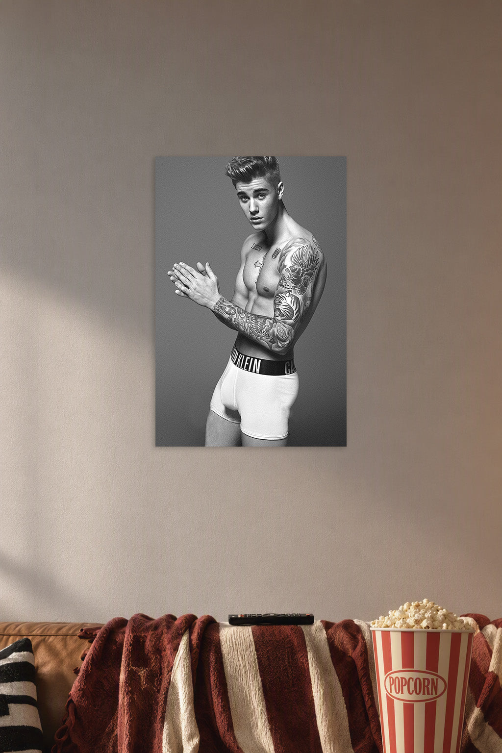Justin Bieber in a cozy movie room above a brown sofa with popcorn.