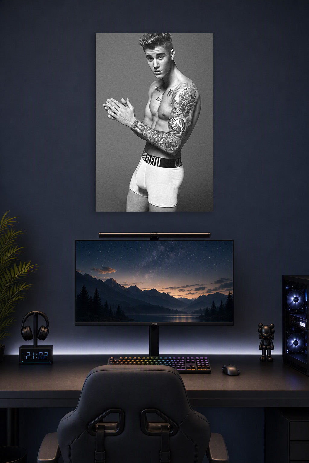 Justin Bieber in a gaming desk setup above a monitor.