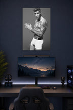Justin Bieber in a gaming desk setup above a monitor.