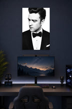 Justin Timberlake in a gaming desk setup above a monitor.
