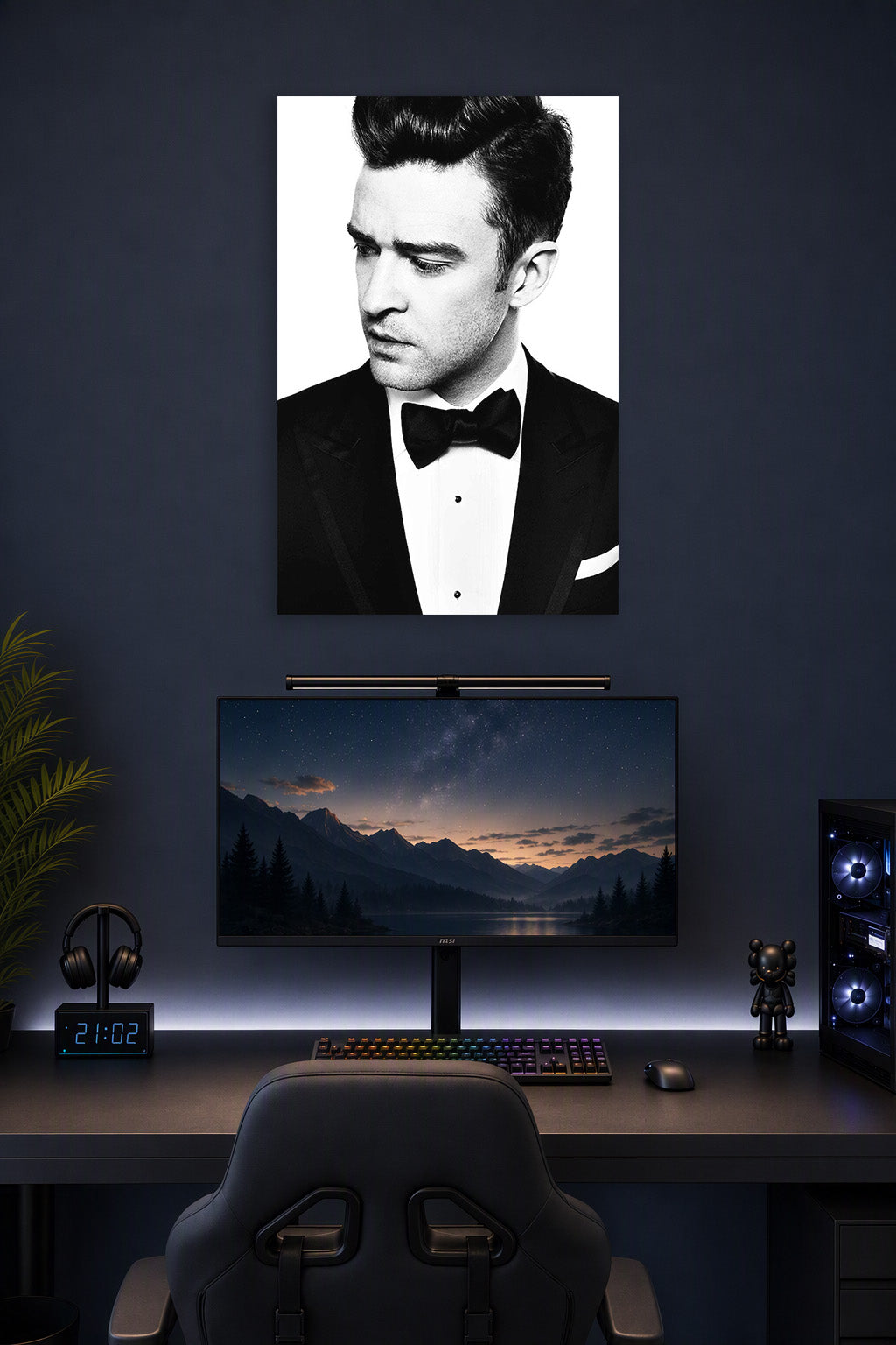 Justin Timberlake in a gaming desk setup above a monitor.