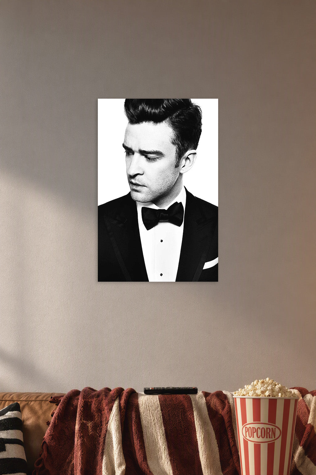 Justin Timberlake in a cozy movie room above a brown sofa with popcorn.