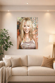 Kaley Cuoco in a bright living room above a beige sofa.