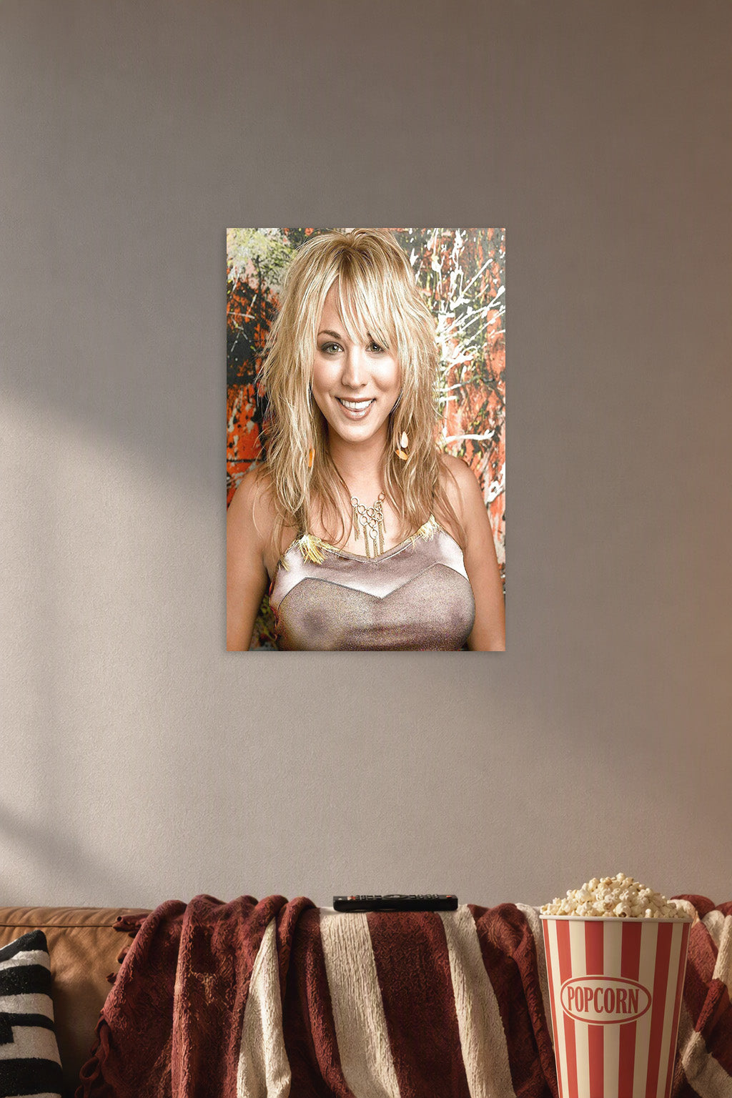 Kaley Cuoco in a cozy movie room above a brown sofa with popcorn.