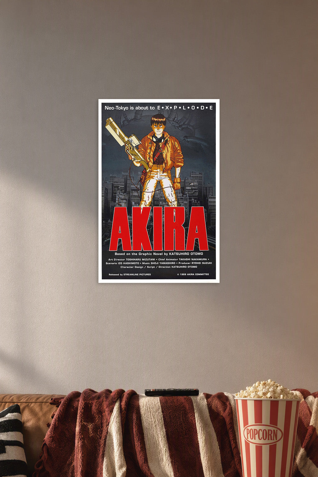 Kaneda Akira in a cozy movie room above a brown sofa with popcorn.