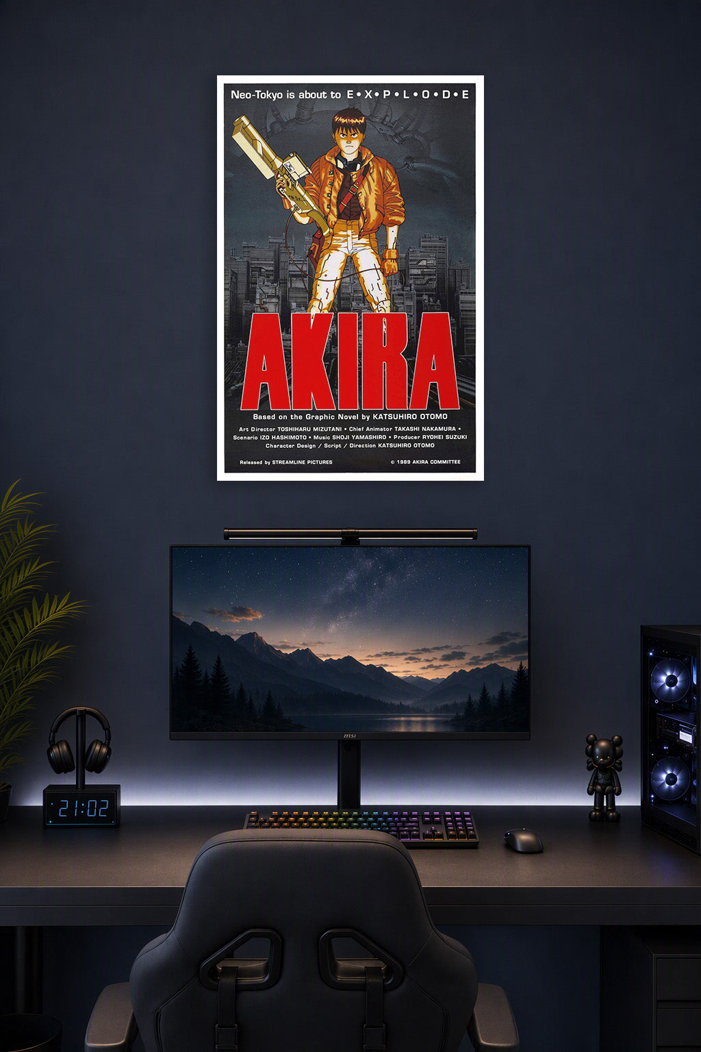 Kaneda Akira in a gaming desk setup above a monitor.