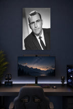 Karl Malden in a gaming desk setup above a monitor.