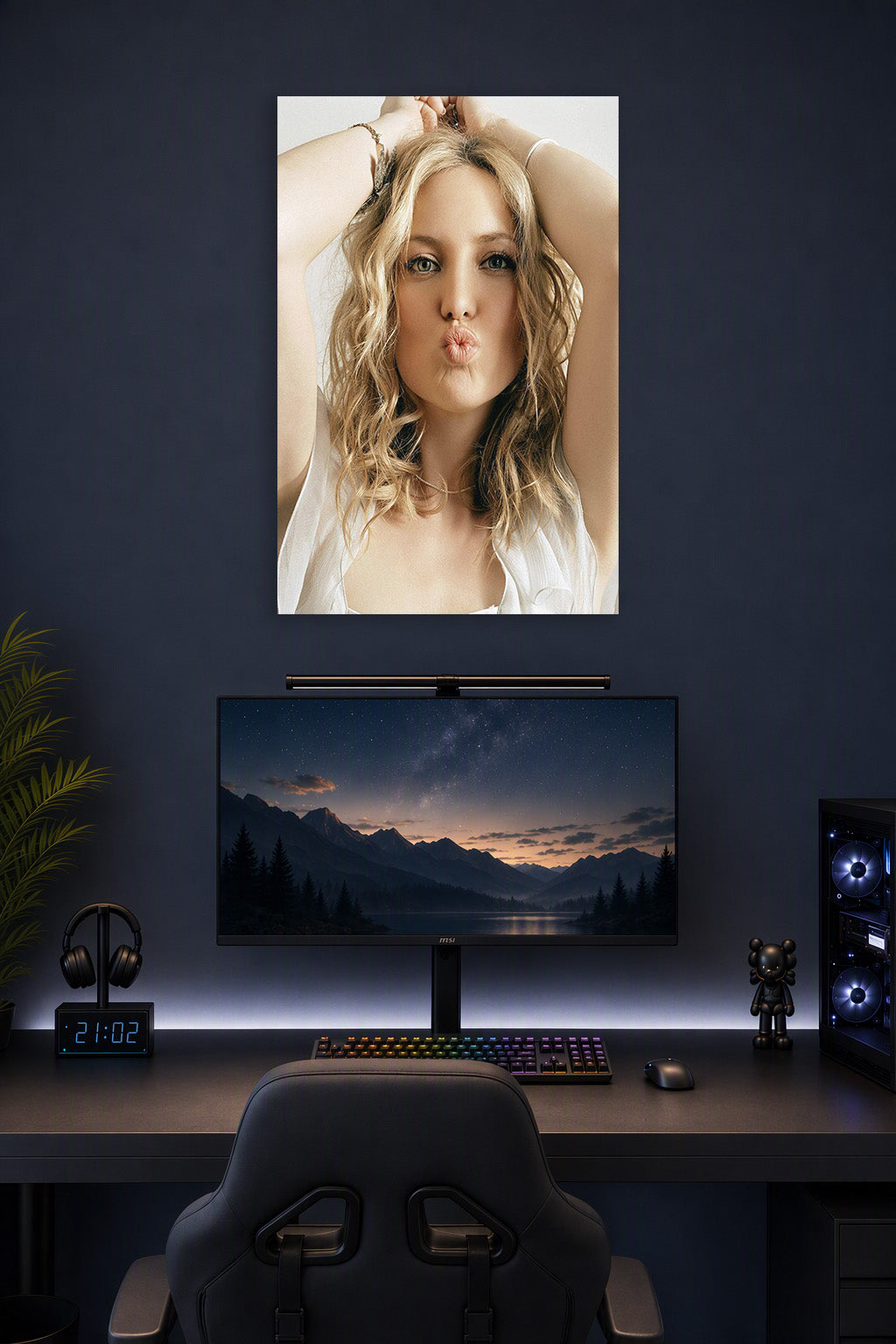 Kate Hudson in a gaming desk setup above a monitor.