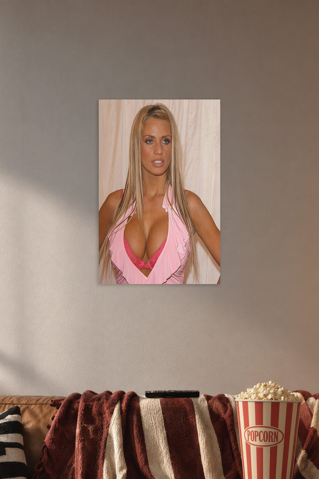 Katie Price in a cozy movie room above a brown sofa with popcorn.