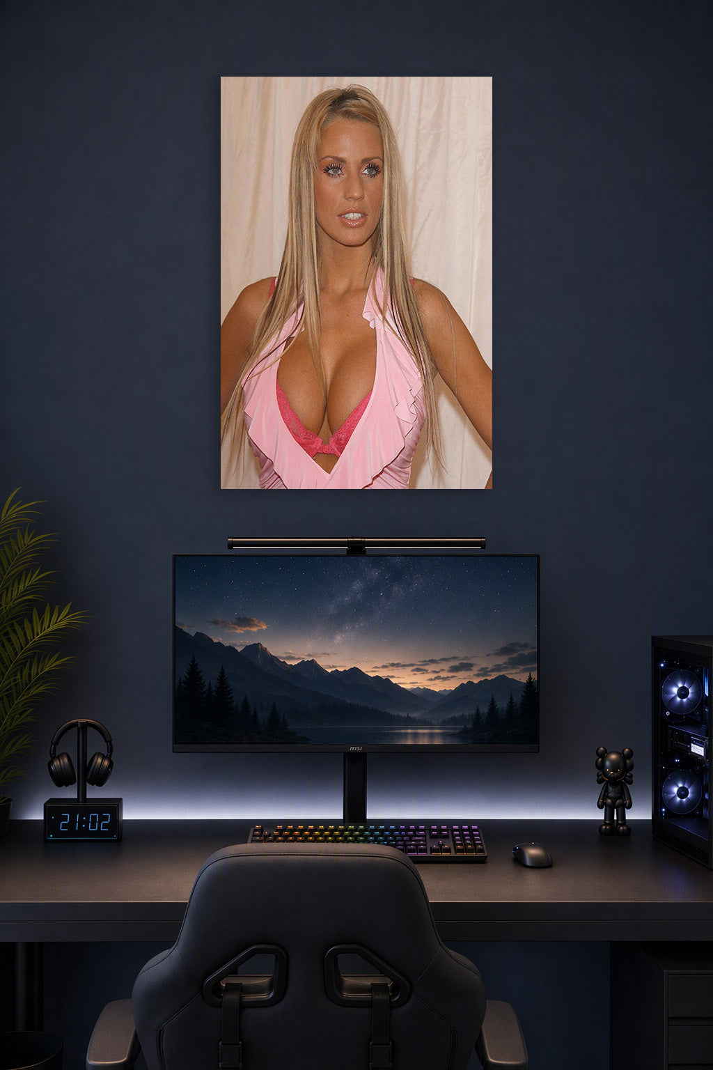 Katie Price in a gaming desk setup above a monitor.