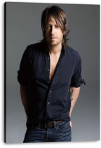 Keith Urban canvas wall art print presents a full-length studio portrait in a dark button-down shirt and blue jeans on gray.