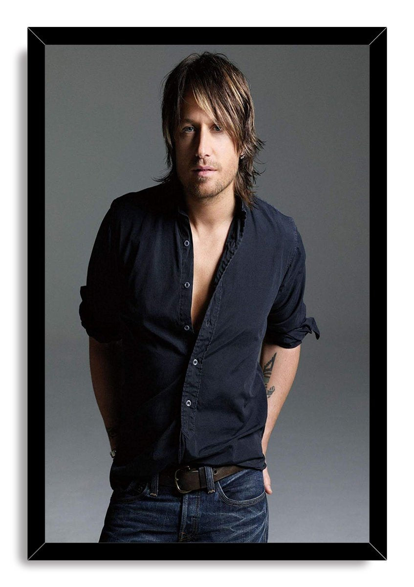 Keith Urban framed wall art print displays a studio portrait in a black frame, with dark shirt, jeans, and gray backdrop.