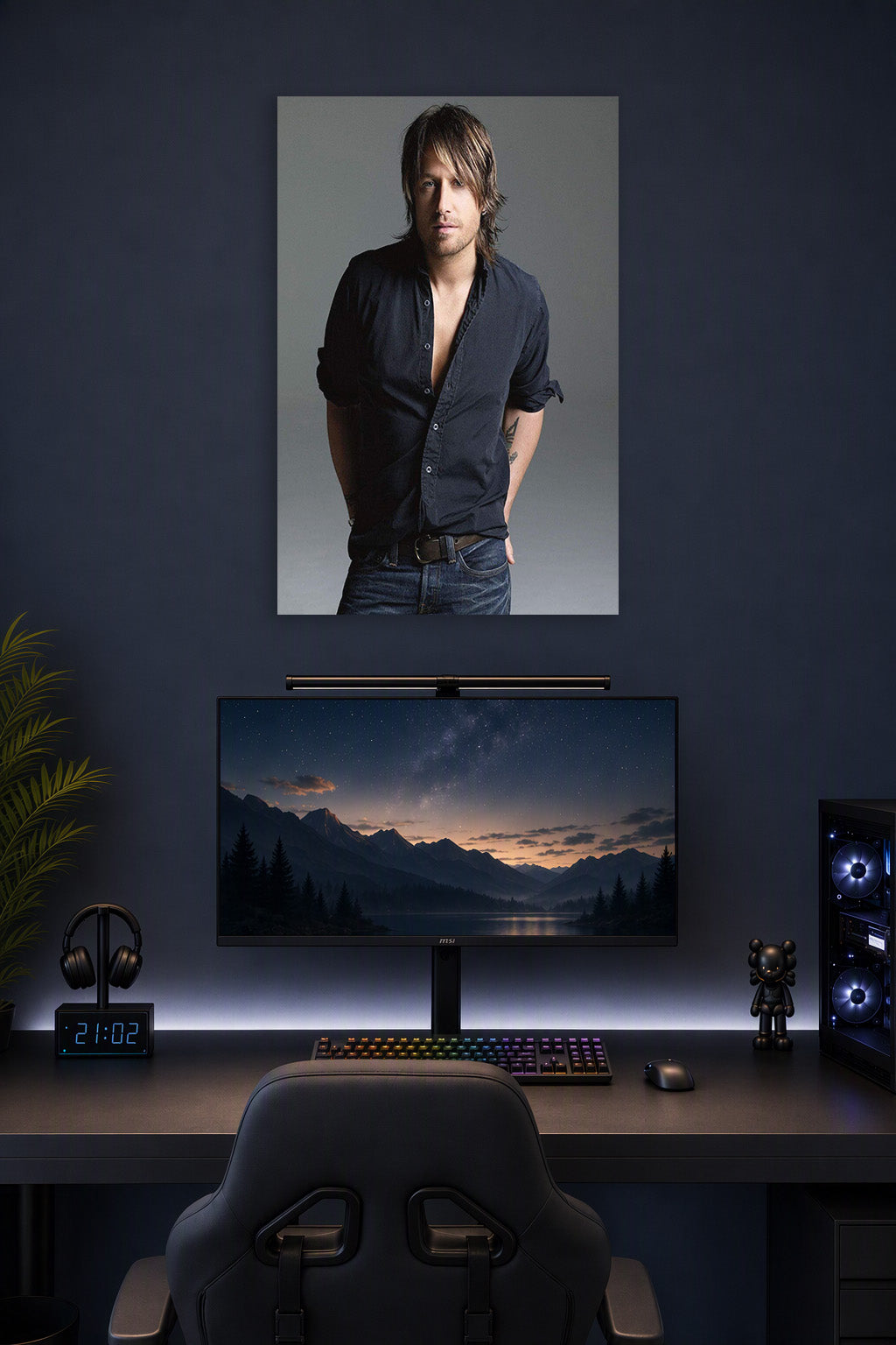 Keith Urban in a gaming desk setup above a monitor.