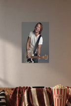 Keith Urban in a cozy movie room above a brown sofa with popcorn.