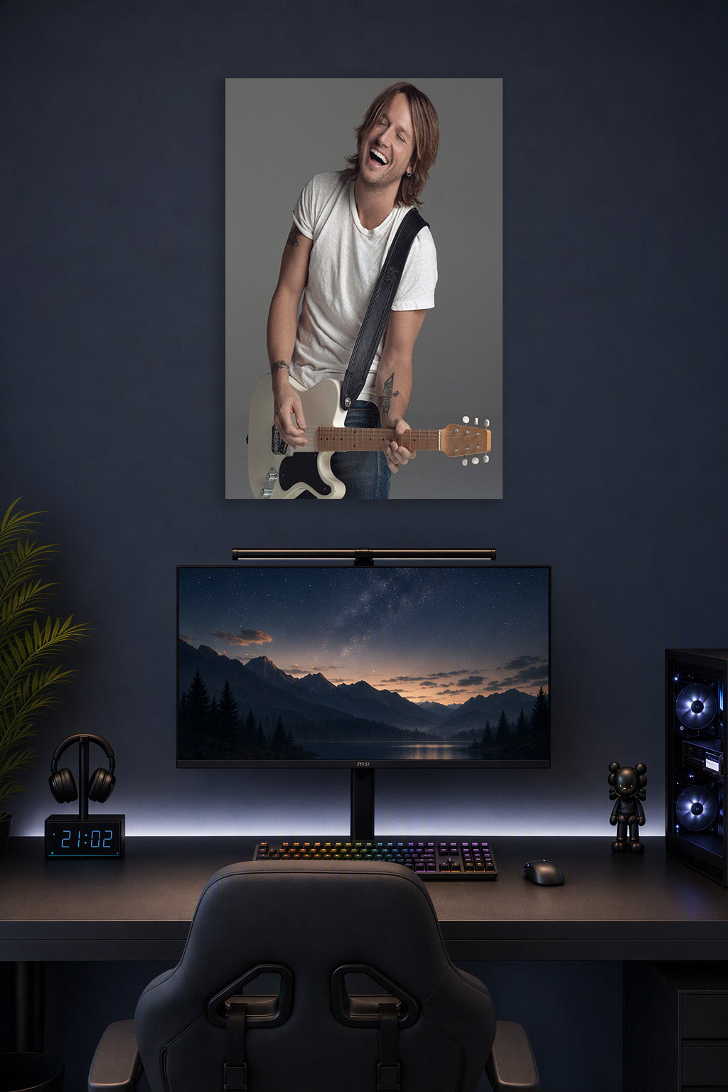 Keith Urban in a gaming desk setup above a monitor.