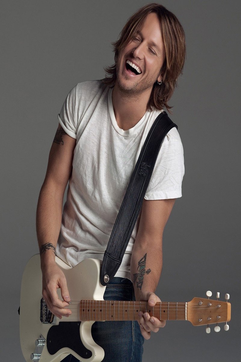Keith Urban wall art print portrays the smiling musician in a white T-shirt playing a cream electric guitar against gray.