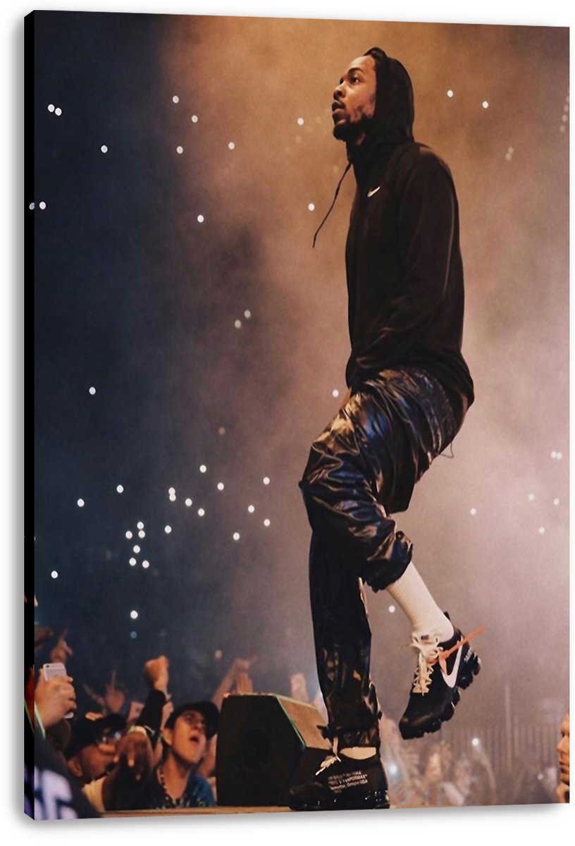 Kendrick Lamar canvas wall art print presents the rapper mid-step above fans, dressed in dark streetwear against smoky amber lighting.
