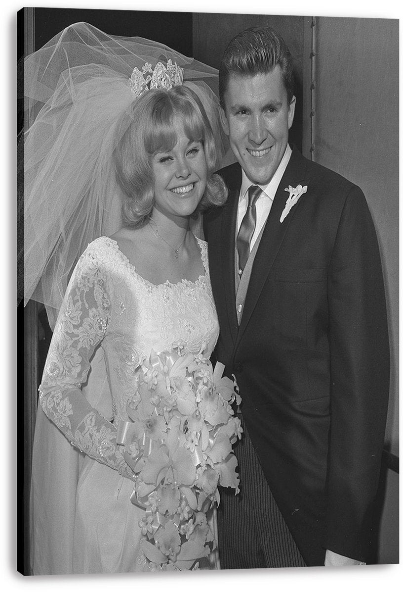 Kenny Lynch wedding canvas wall art print displays a monochrome portrait of the smiling couple in formal bridal attire.