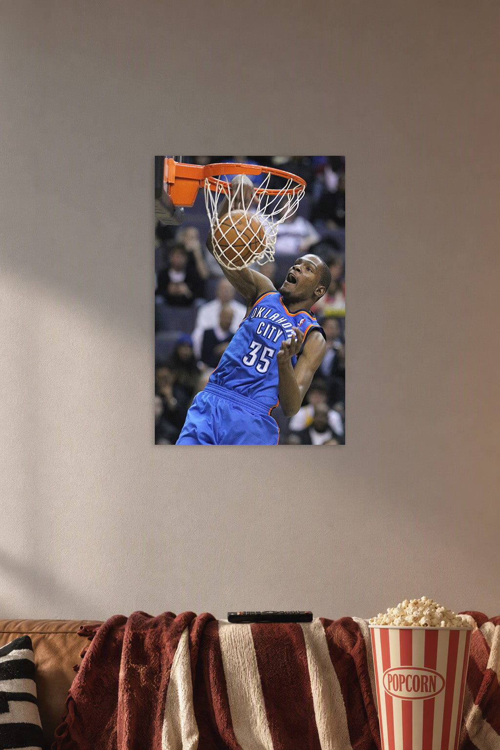 Kevin Durant Slam Dunk in a cozy movie room above a brown sofa with popcorn.