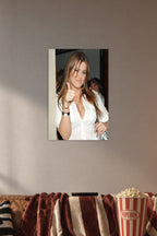 Khloé Kardashian in a cozy movie room above a brown sofa with popcorn.