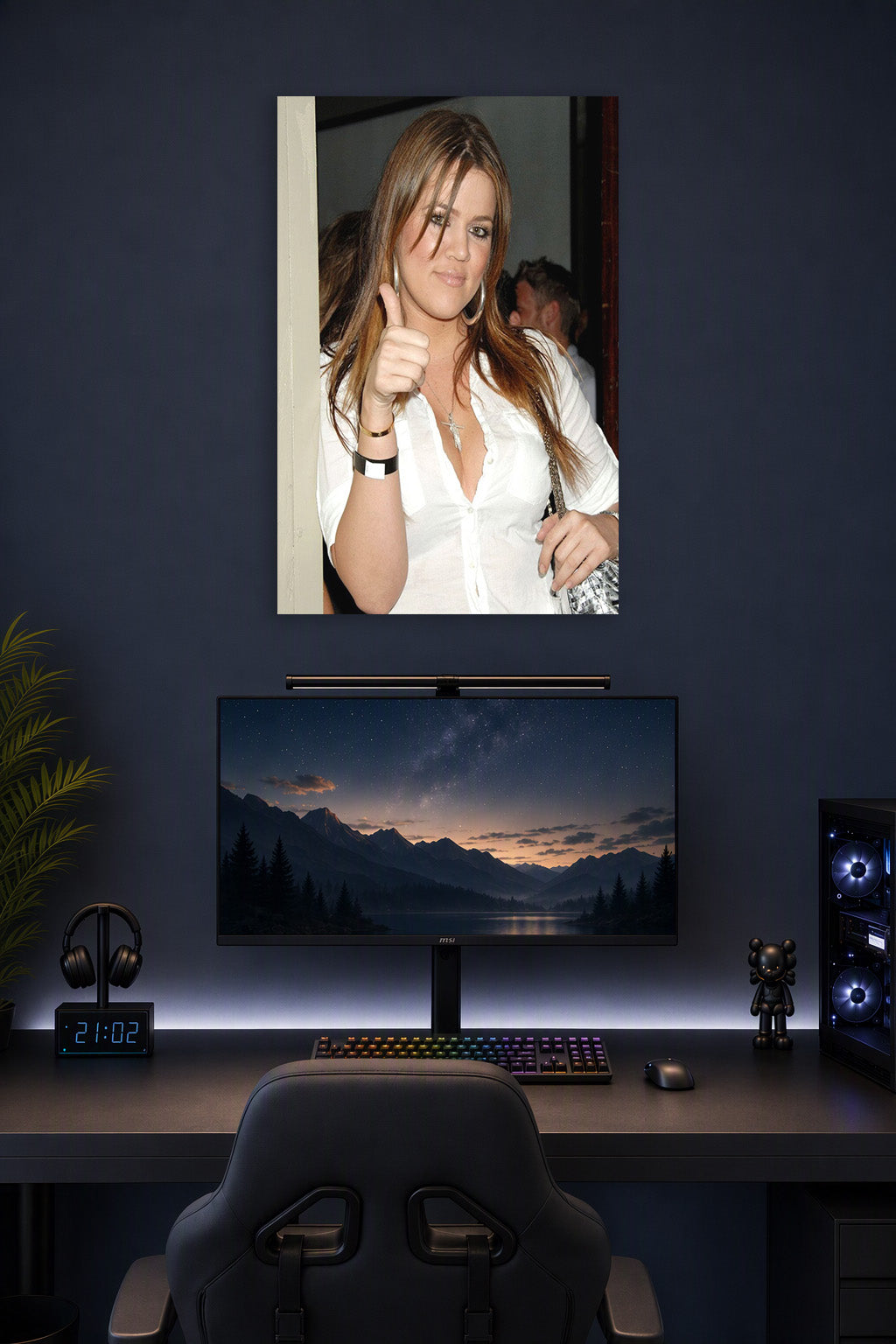 Khloé Kardashian in a gaming desk setup above a monitor.