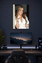 Khloé Kardashian in a gaming desk setup above a monitor.
