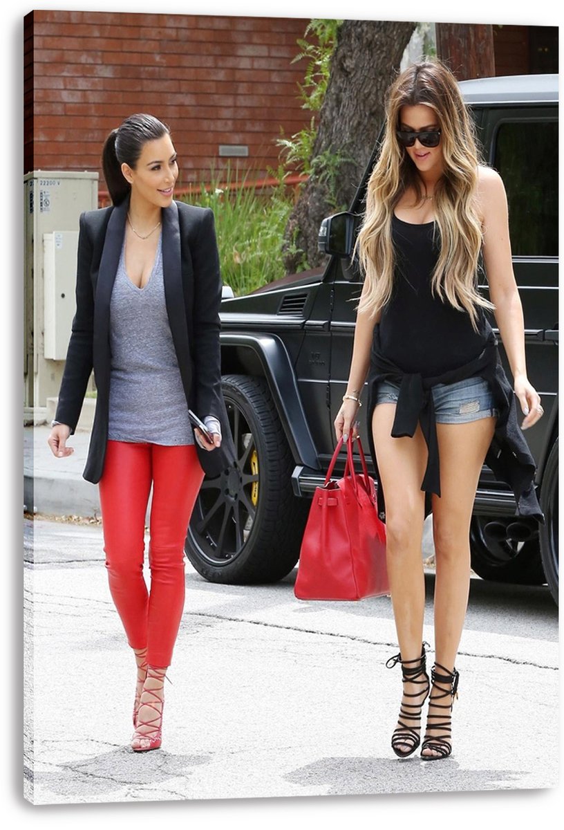 Kim and Khloé Kardashian canvas wall art print displaying the sisters walking outdoors beside a black SUV and carrying a red handbag.