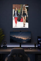 Kim and Khloé Kardashian in a gaming desk setup above a monitor.