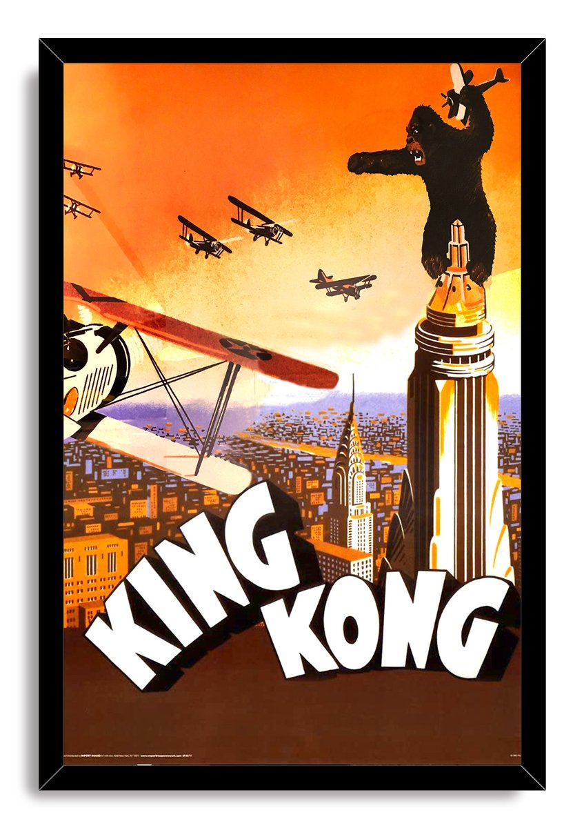 King Kong framed wall art print features biplanes attacking the ape atop the Empire State Building over a stylized city.
