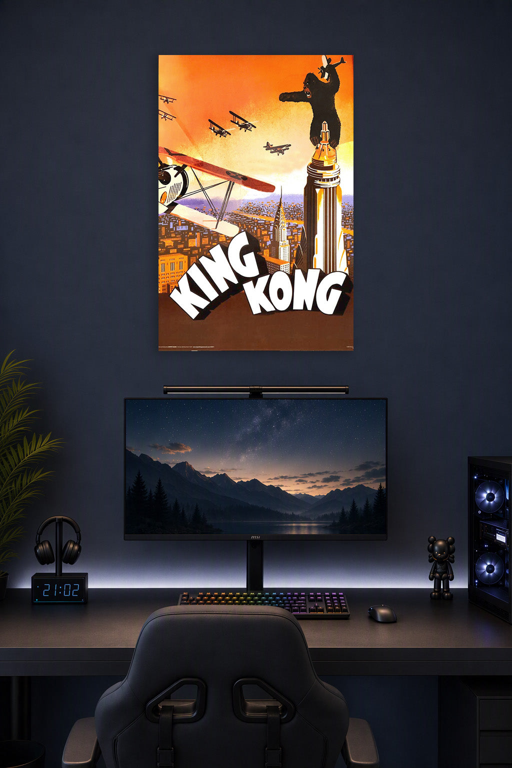 King Kong in a gaming desk setup above a monitor.