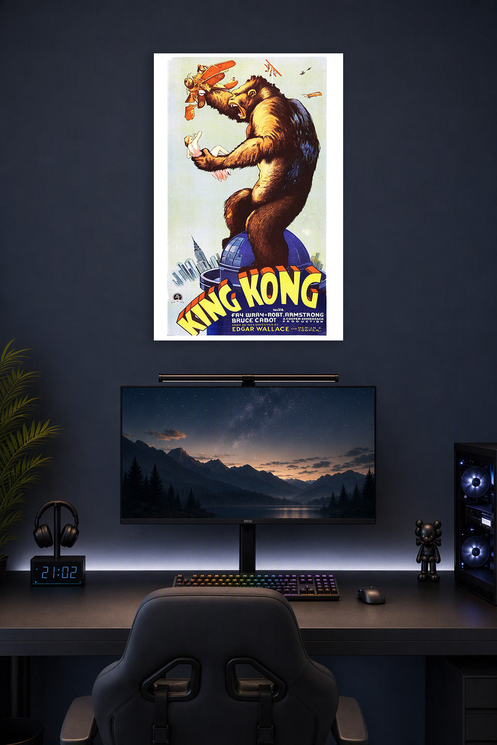 King Kong in a gaming desk setup above a monitor.